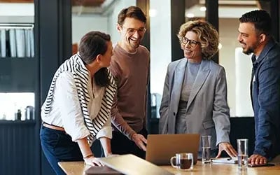 HR professionals smile after choosing Right Management over other executive coaching companies for leadership development. 